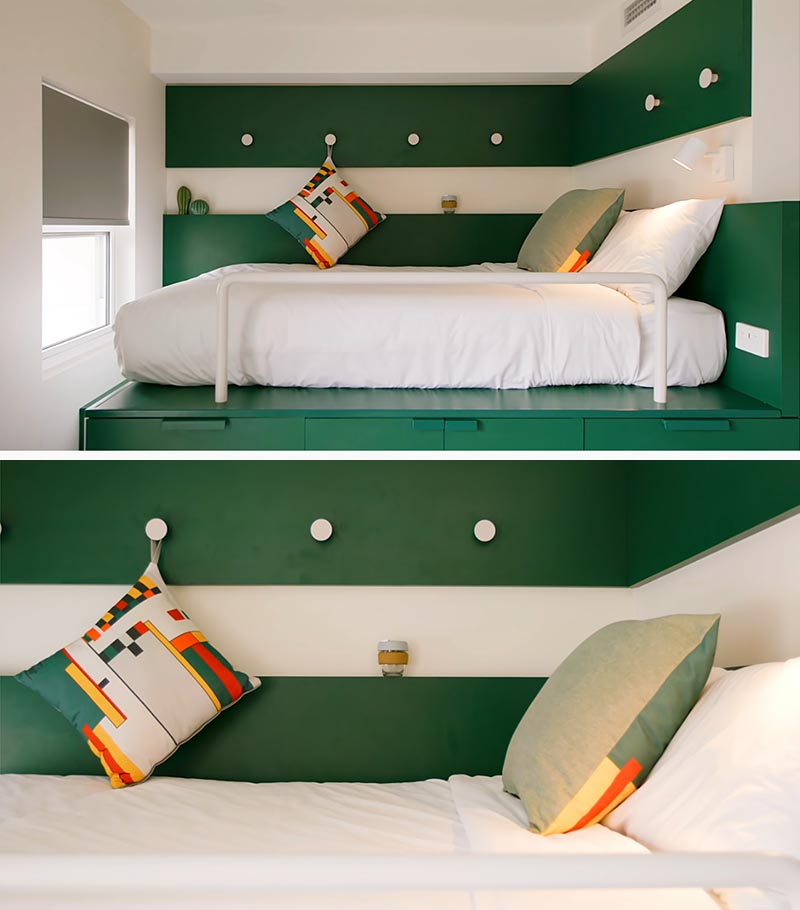 The wrap around paneling in the sleeping area of this platform bed helps to create a bedroom-like feeling, and acts as a small shelf, as well as creates a place to have some hooks, for hanging various items. #PlatformBed #SmallLiving #Bedroom