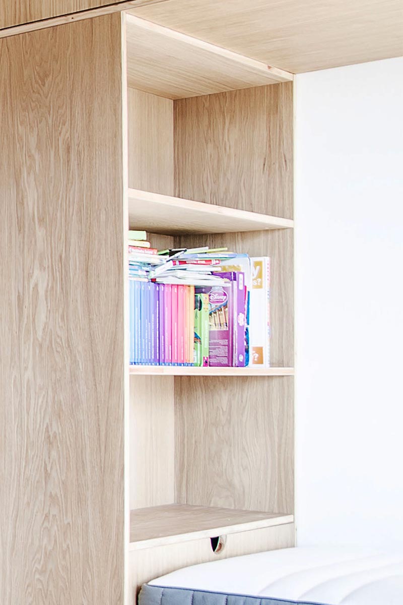 Each bed in this bunk bed built for three, has their own dedicated storage area, where each child can keep their own things easily within reach while in bed. #BunkBed #KidsBedroom #Shelving