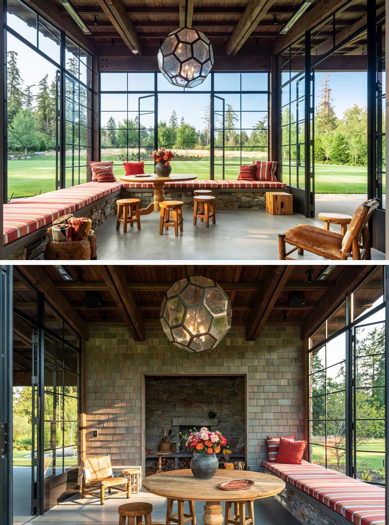 This sun room has plenty of windows looking out onto the field, as well as wrap-around seating and an inglenook. 