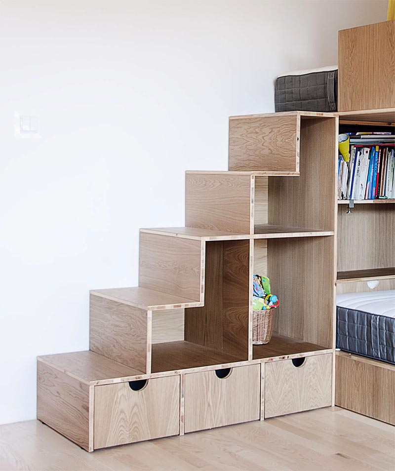 The design of the bunk beds, has the three beds at different levels, with the upper bed accessed via a set of stairs that has open shelving and also doubles as toy storage. #BunkBedStairs #BunkBed #StairsWithStorage #KidsBedroom