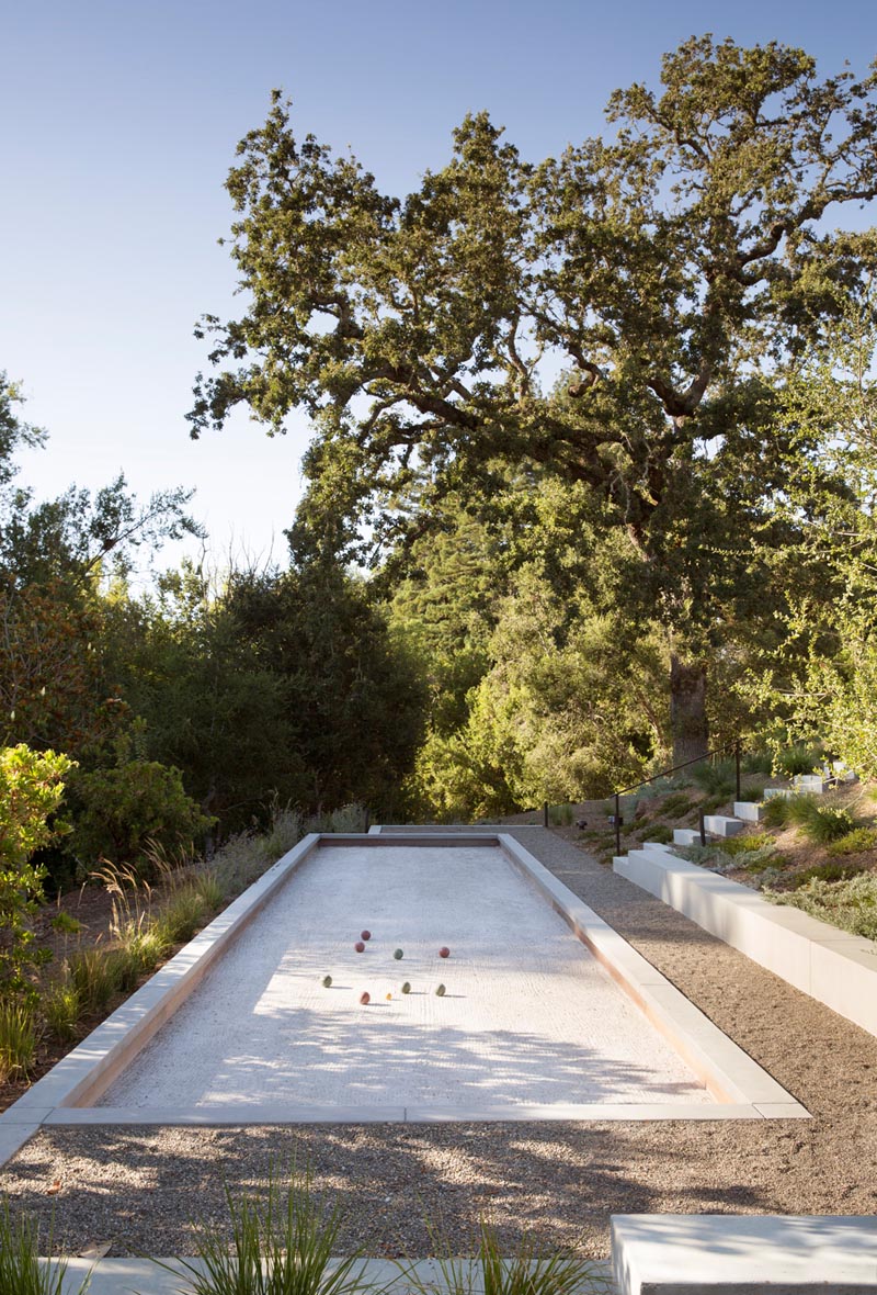 A modern farmhouse yard with a bocce court.