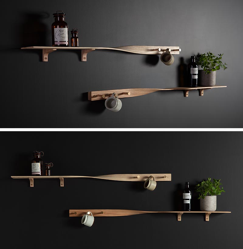 Carefully sculpted from tonal ash wood, the Tor Twist Shelf gently twists in the center and elevates itself above three brushed brass tipped coat pegs. #WoodShelving #WallShelf #ModernShelf #KitchenShelving #EntrywayShelf