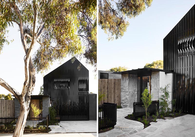 The 'Cornerstone House' features a facade of black steel cladding, and a dozen large rough boulders positioned at key moments throughout the exterior and interior of the home, like the entryway, where they flank either side of the front door. #Architecture #ModernHouse #Stone #Boulders