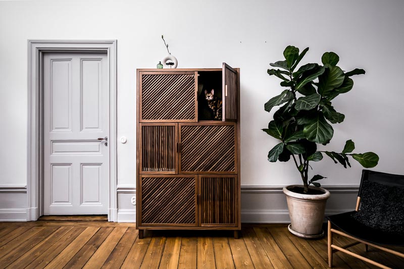 The Cat Flat is a modern three level cabinet designed for cats. It has various textures, scratching poles, brushes, openings and tunnels, as well as a hammock. #CatFurniture #CatCabinet #PetFurniture #Cats #FurnitureDesign #Design