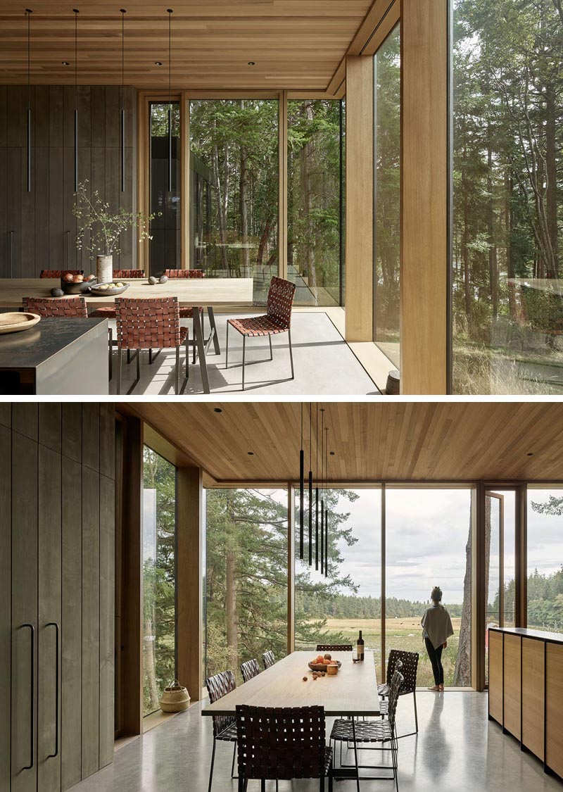 This modern and open plan dining area is defined by five minimalist pendant lights hanging above the wood table. #DiningRoom #DiningArea