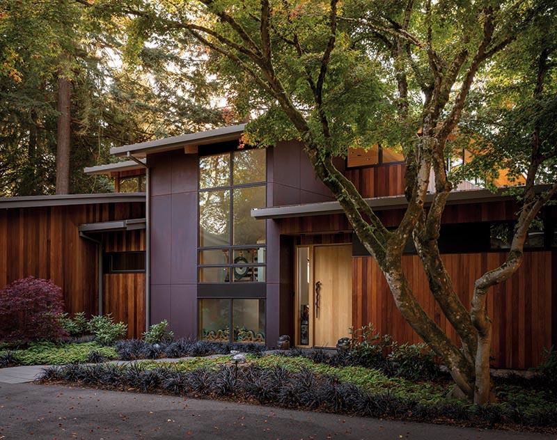 This modern single-family house with exterior materials of ipe wood siding and weathering steel.