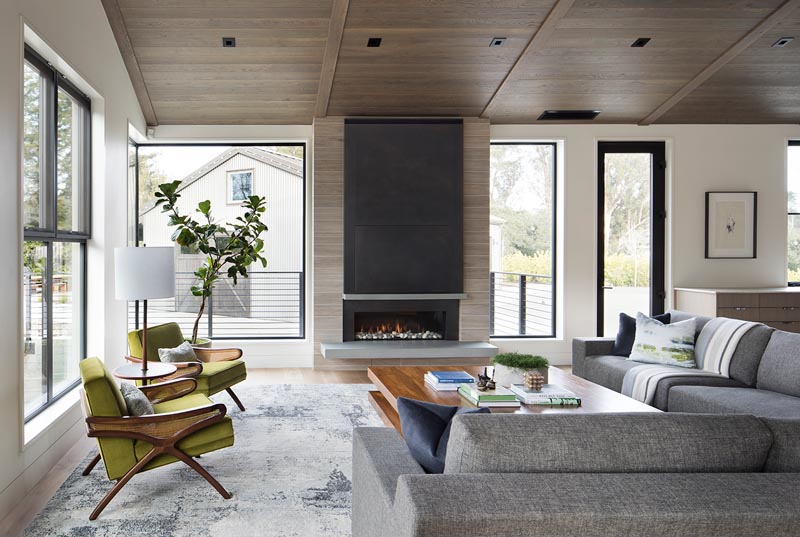 A linear fireplace with a steel surround and a cantilevered hearth.