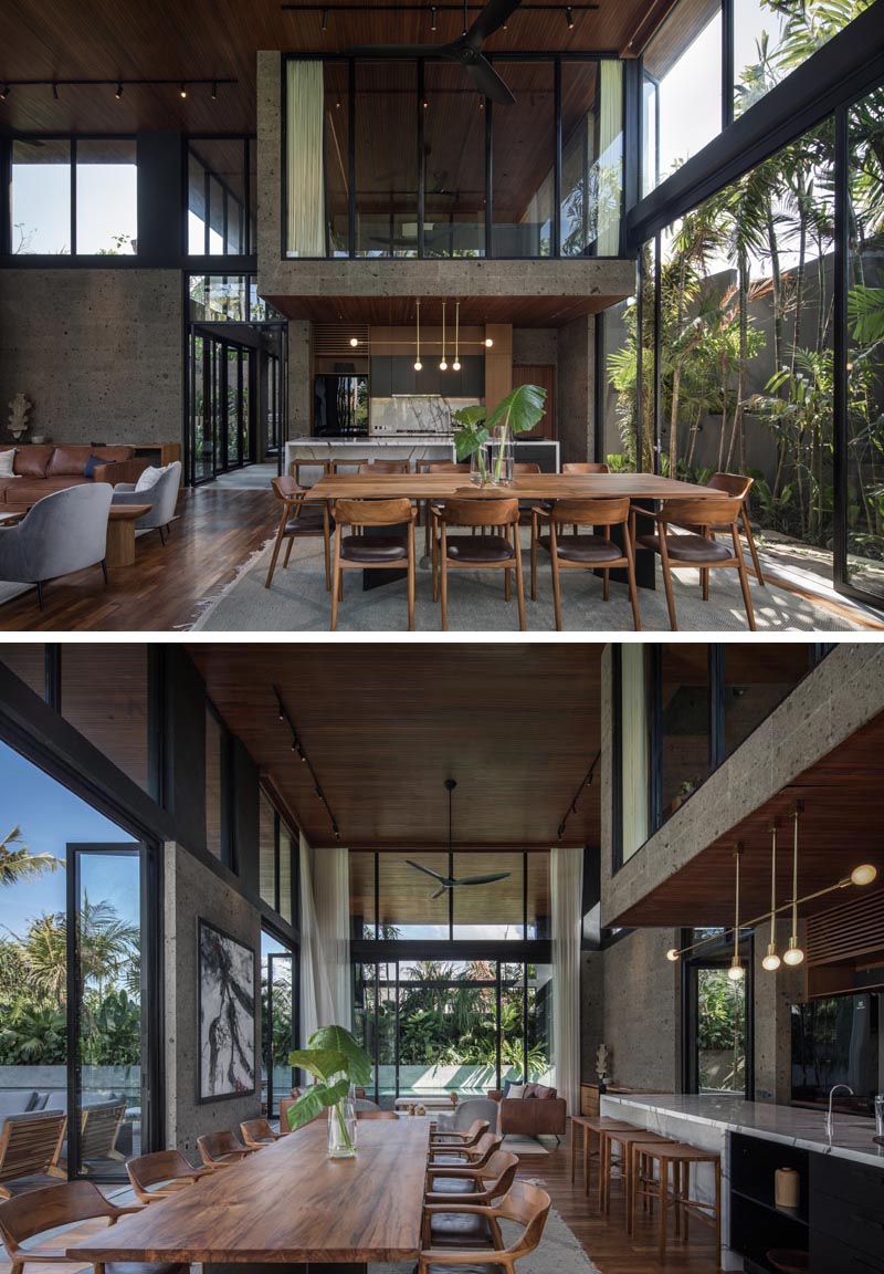 Wood furnishings inside this modern house complement the wood ceiling that travels through to the exterior and creates a partially covered outdoor entertaining space. #WoodCeiling #OpenPlanInterior #ModernInterior #ModernHouse
