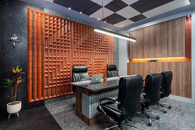 Using a variety of custom terracotta tiles, the designers were able to create a unique large wall art installation that adds interest to the office and complements other tile work found throughout the office. #WallArt #OfficeDesign #TileArt #TerracottaTiles