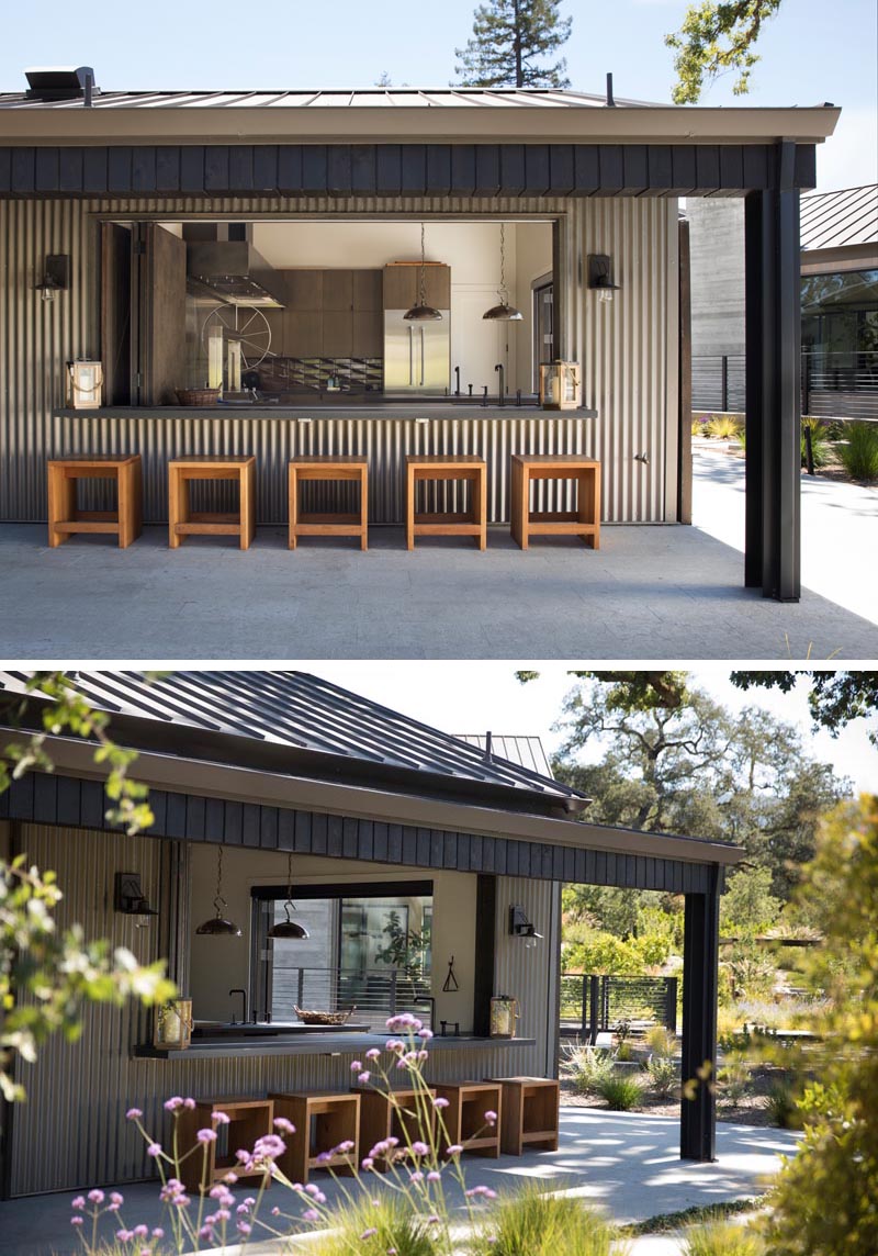 A custom outdoor kitchen with bar seating and patio.