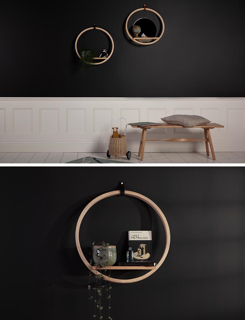 A round wood wall shelf with a circular design and a mirror.