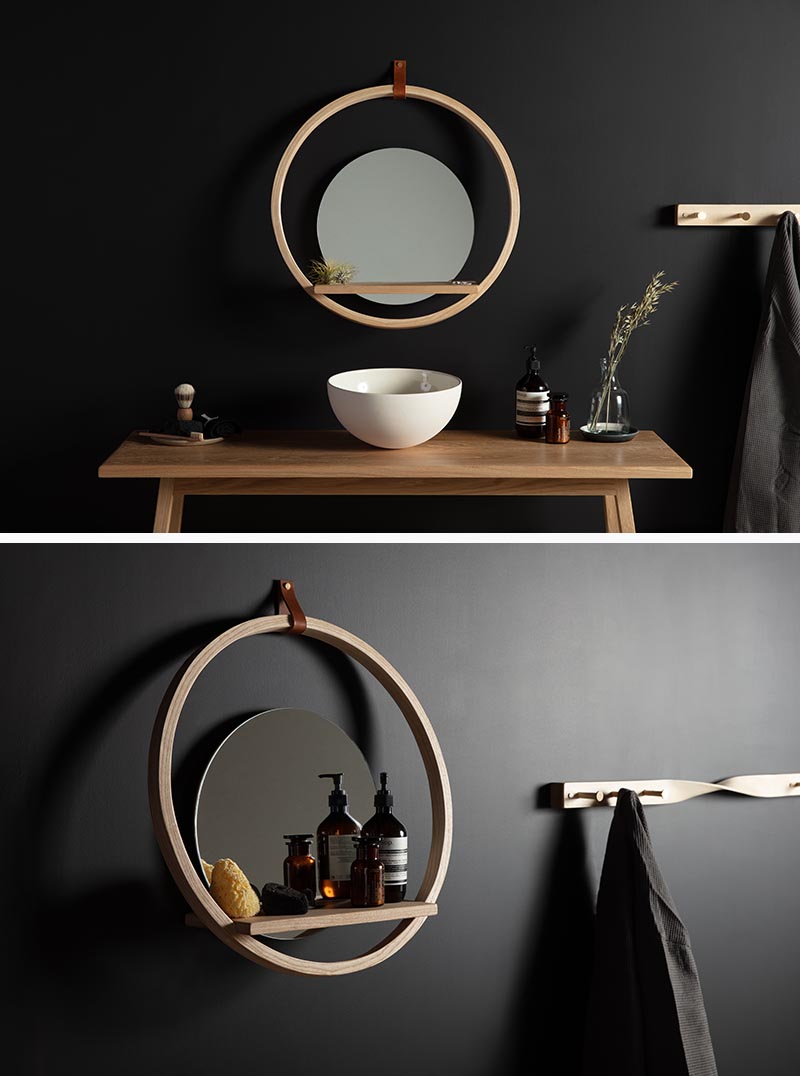A modern round wall shelf with a ledge and mirror.