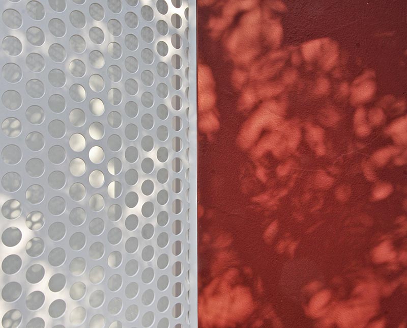 A perforated metal screen is used to provide this micro-apartment with shade and privacy. #PerforatedScreen #MetalScreen #Architecture