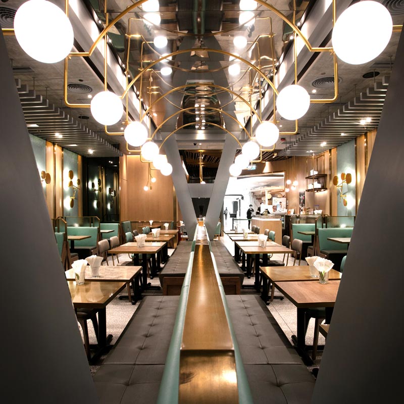 A modern restaurant with banquette seating. #Restaurant #BanquetteSeating