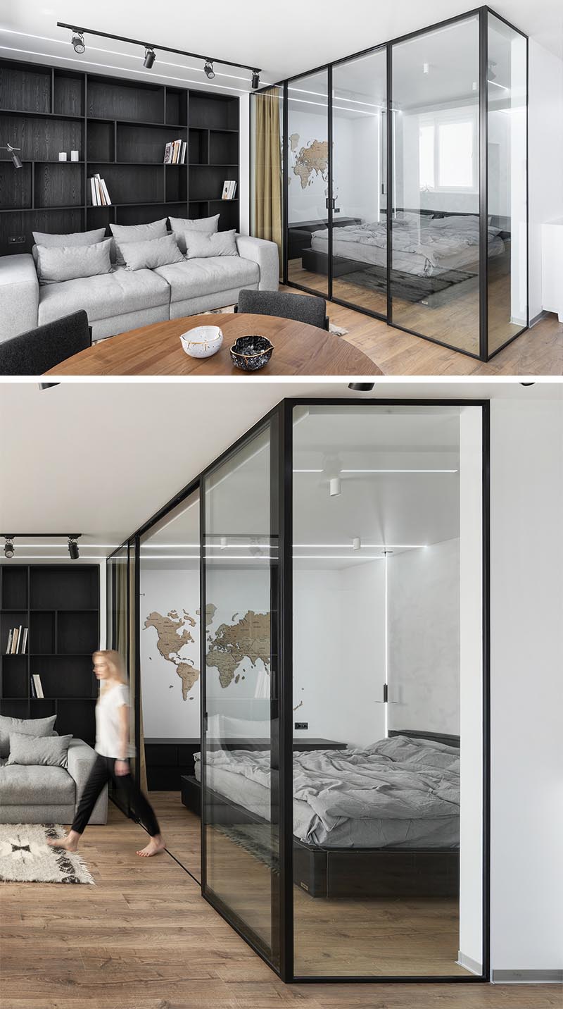 Located directly off the living room of this modern apartment, is a glass enclosed bedroom that provides separation from the rest of the apartment, but at the same time allows the natural light from the window to travel through to the bedroom. #GlassEnclosedBedroom #ModernApartment #BedroomDesign