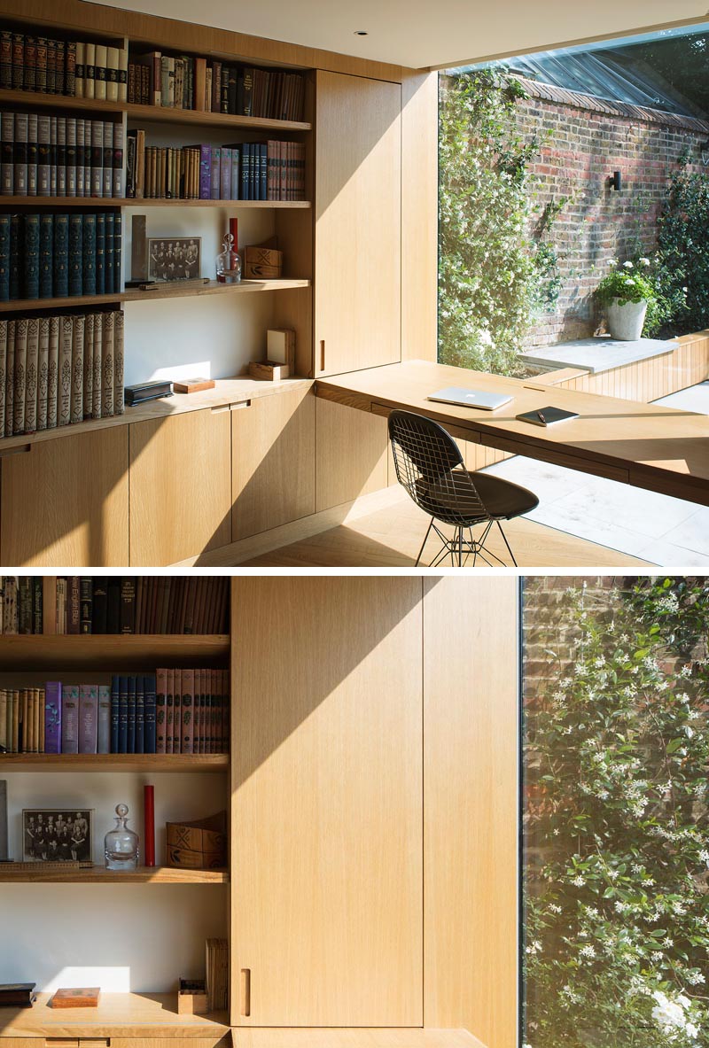 The modern home office desk is positioned to take advantage of the garden view through the large picture window. #HomeOffice #Shelving #Desk #PictureWindow