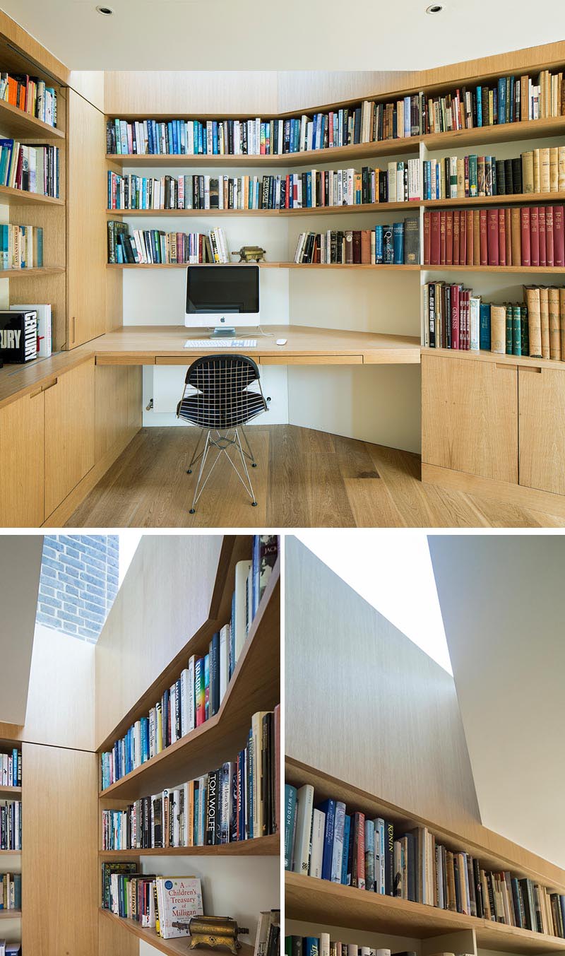 Inside this modern home office, bespoke joinery and desks are carefully integrated into the design of the extension, providing a home for an extensive collection of artifacts and books collected over the years. A skylight helps provide natural light to the first desk area. #HomeOffice #Desk #Bookshelves #Skylight