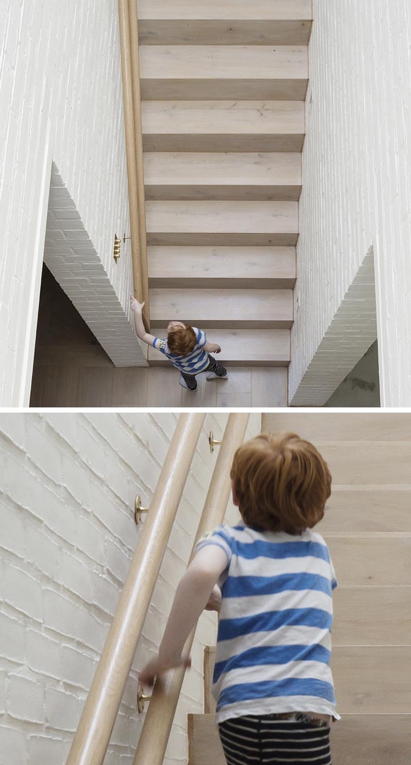 Architecture firm Peter Legge Associates completed a house in Dublin, Ireland, and as part of the design of the stairs, they included a wood handrail that can be used by both adults and children. #StairDesign #HandrailDesign #MultiHeightHandrail