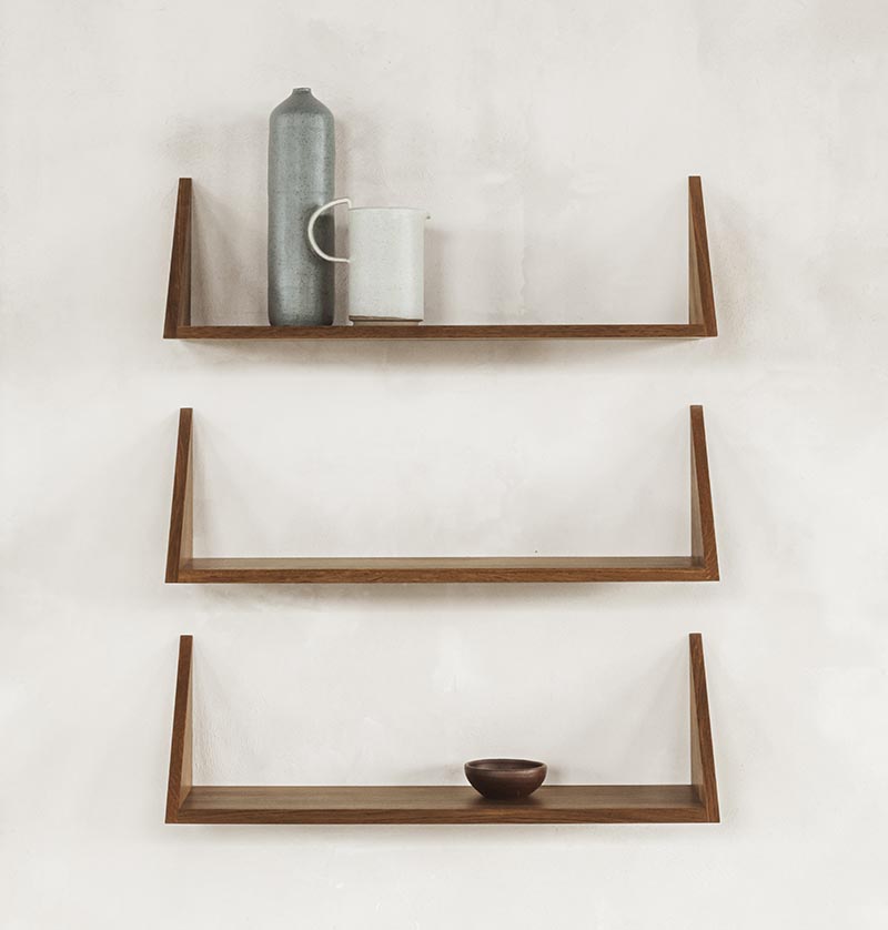 A collection of three floating wall shelves.