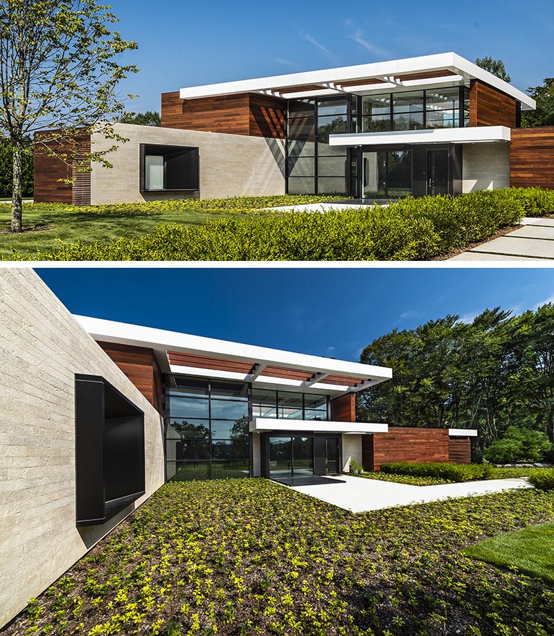 The oversized black steel-clad window frame intentionally juts from the stone entry wall of this modern house, and with its design, it casts a variety of shadows throughout the day, depending on the sunlight or the light coming from within the house. #ProtrudingWindow #WindowDesign #ModernArchitecture #ModernHouse