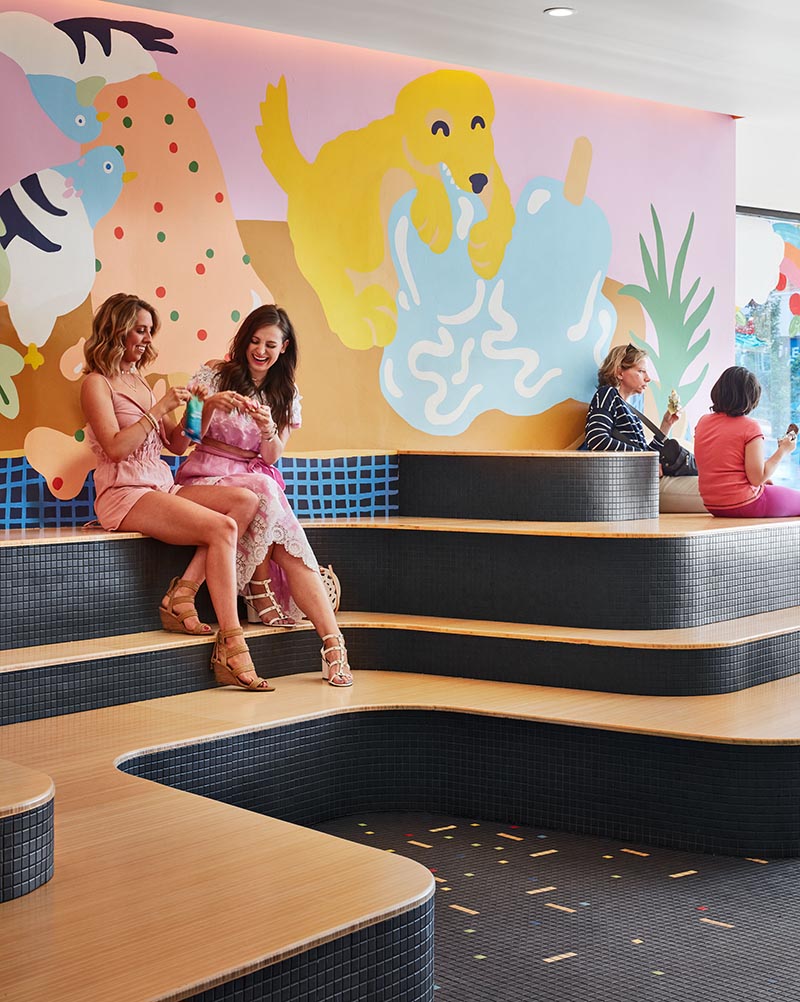 In the recently completed Pretty Cool Ice Cream Shop in Chicago, Illinois, Tumu Studio created a sculptural tiered seating element for visitors of the shop to relax on. #TieredSeating #RetailDesign #IceCreamShop #InteriorDesign