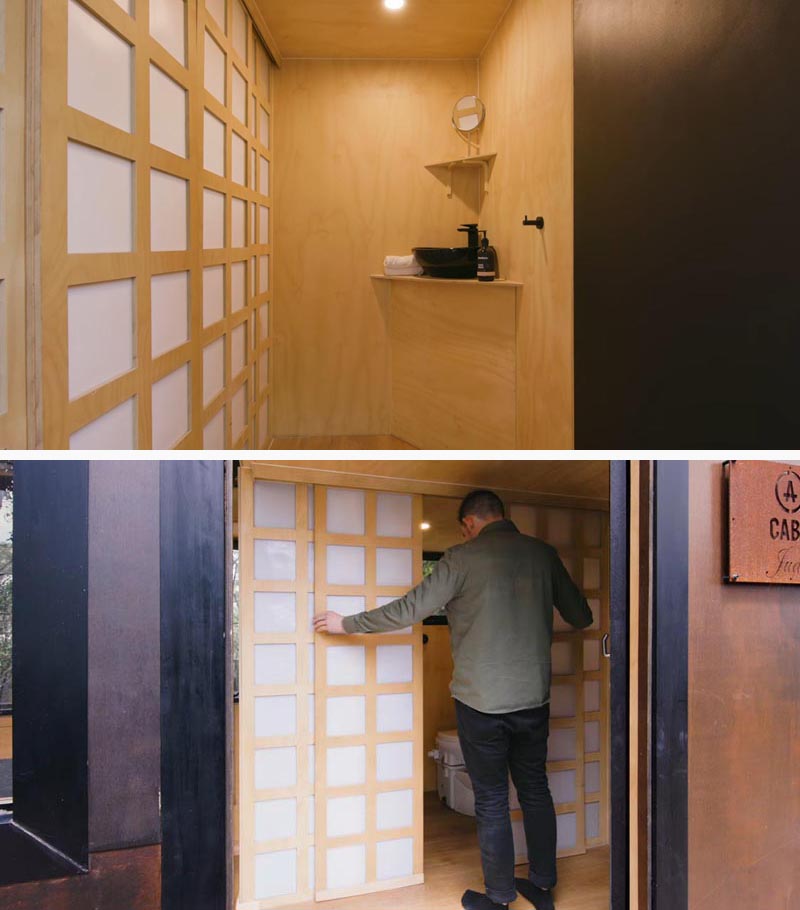 In this modern tiny home, Japanese inspired screen doors hide the bathroom from view and still let light in. #TinyHome #TinyHouse #ScreenDoor #BathroomDoor