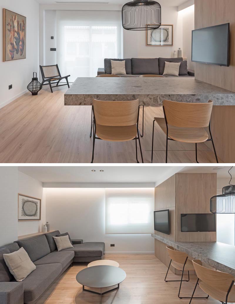 This dining area with a cantilevered table top is used to create a separation between the living room and the kitchen. #Cantilevered #CantileveredDiningTable #InteriorDesign #DiningRoom