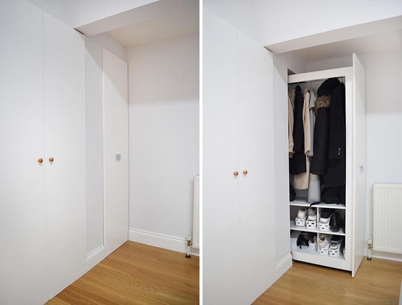 Stepping inside this renovated home, there's a small and narrow entryway, where the designer integrated a pull-out cabinet that would be easy to use and have enough capacity for several coats and shoes in its lower area. #CoatCloset #EntrywayCloset #PullOutCloset