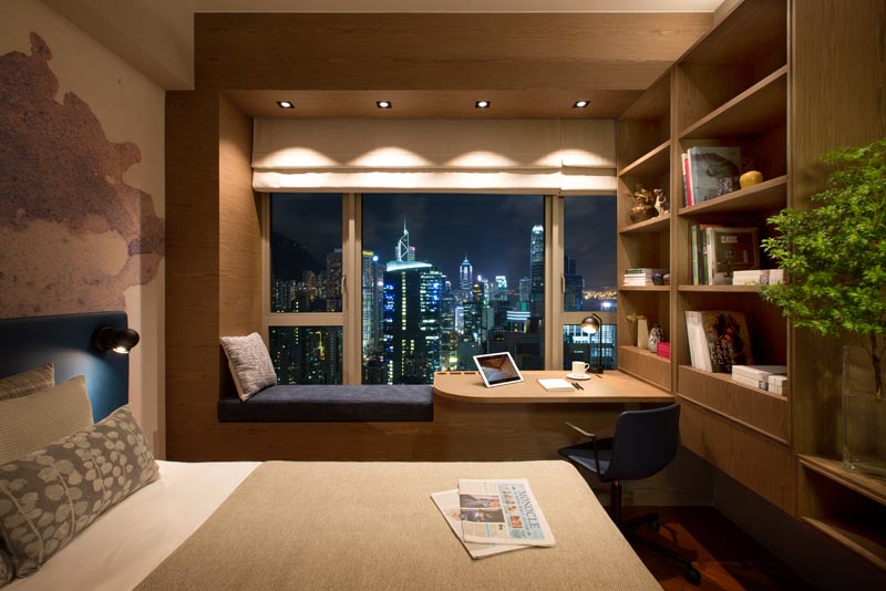 As part of a co-living / workspace in Hong Kong, Adapa Architects Limited designed a bedroom that features a combined window seat and desk. #BedroomIdeas #BedroomDesign #WindowSeat #BuiltInDesk #DeskIdeas