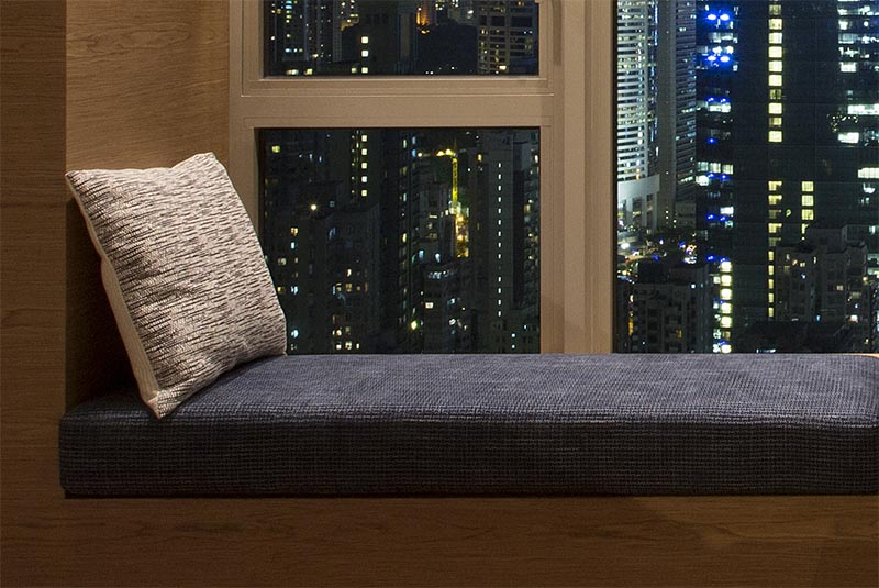 As part of a co-living / workspace in Hong Kong, Adapa Architects Limited designed a bedroom that features a combined window seat and desk. #BedroomIdeas #BedroomDesign #WindowSeat #BuiltInDesk #DeskIdeas