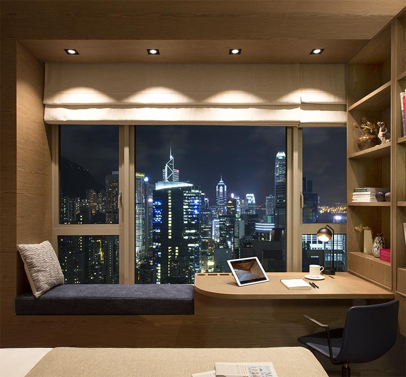 As part of a co-living / workspace in Hong Kong, Adapa Architects Limited designed a bedroom that features a combined window seat and desk. #BedroomIdeas #BedroomDesign #WindowSeat #BuiltInDesk #DeskIdeas