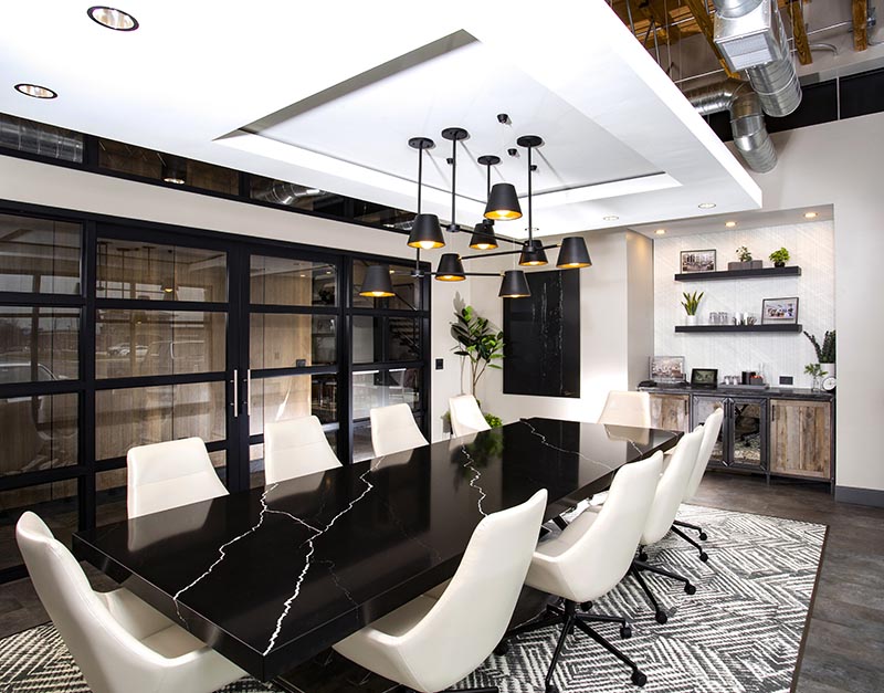 This modern conference room makes use of a suspended ceiling to partially hide the exposed ducting above and allow for the incorporation a statement light fixture. #InteriorDesign #SuspendedCeiling #CeilingDesign #Lighting #Workplace #ConferenceRoom