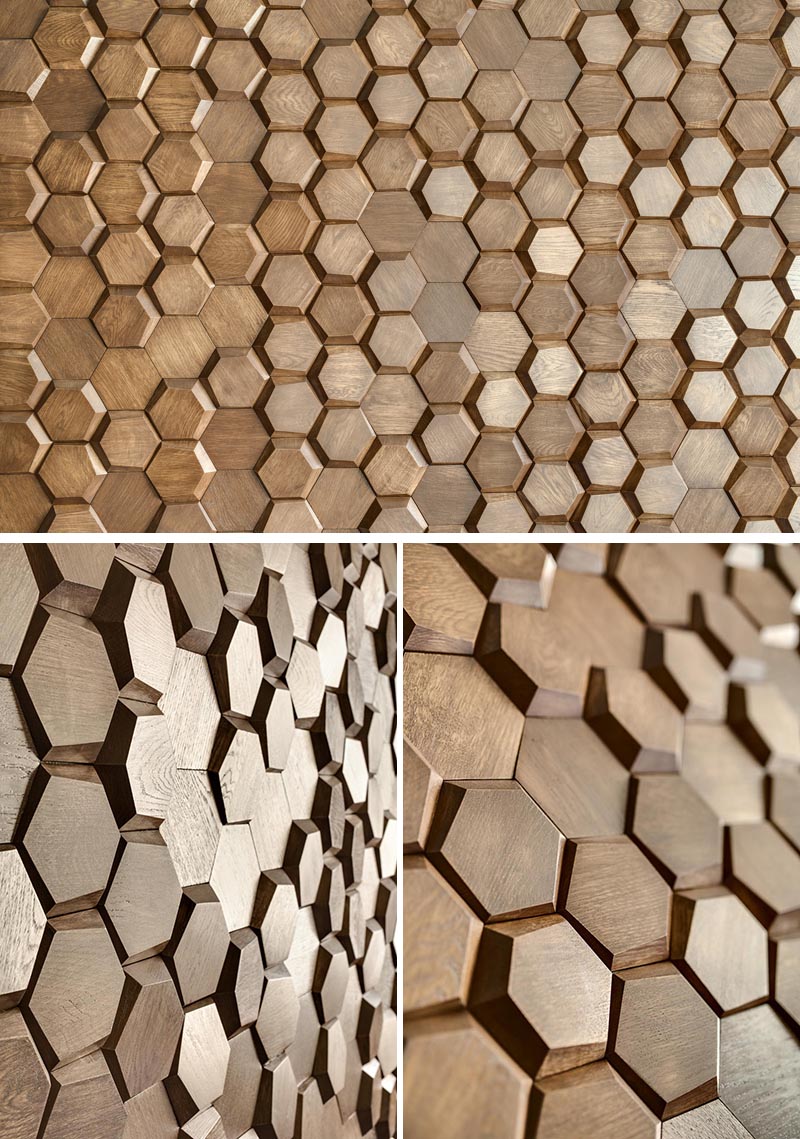 This modern bedroom has an eye-catching accent wall made from 3-dimensional hexagonal wood tiles in a honeycomb pattern. #WoodTiles #WoodAccentWall #3DAccentWall #BedroomDesign #InteriorDesign