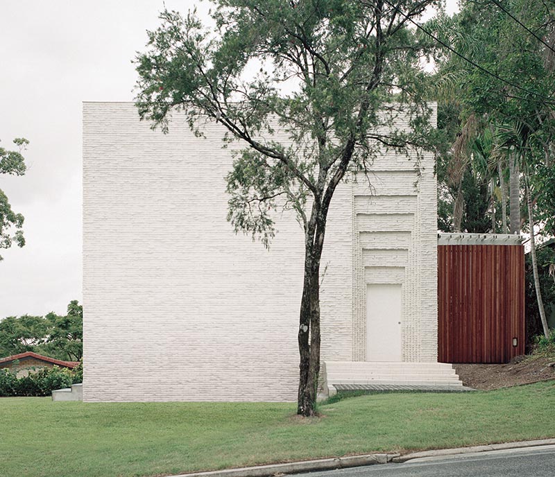 Thin, long off-white bricks were used for the build of the house, and have complementary white mortar. Around the main door to the home, the brickwork is folded in concertinas in a scale, which catches the afternoon sun. #WhiteBricks #WhiteMortar #WhiteHouse #Architecture #Building #Bricks