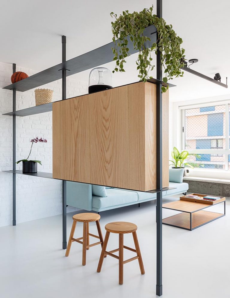 A MultiFunctional Room Divider Helps To Define The Spaces In This