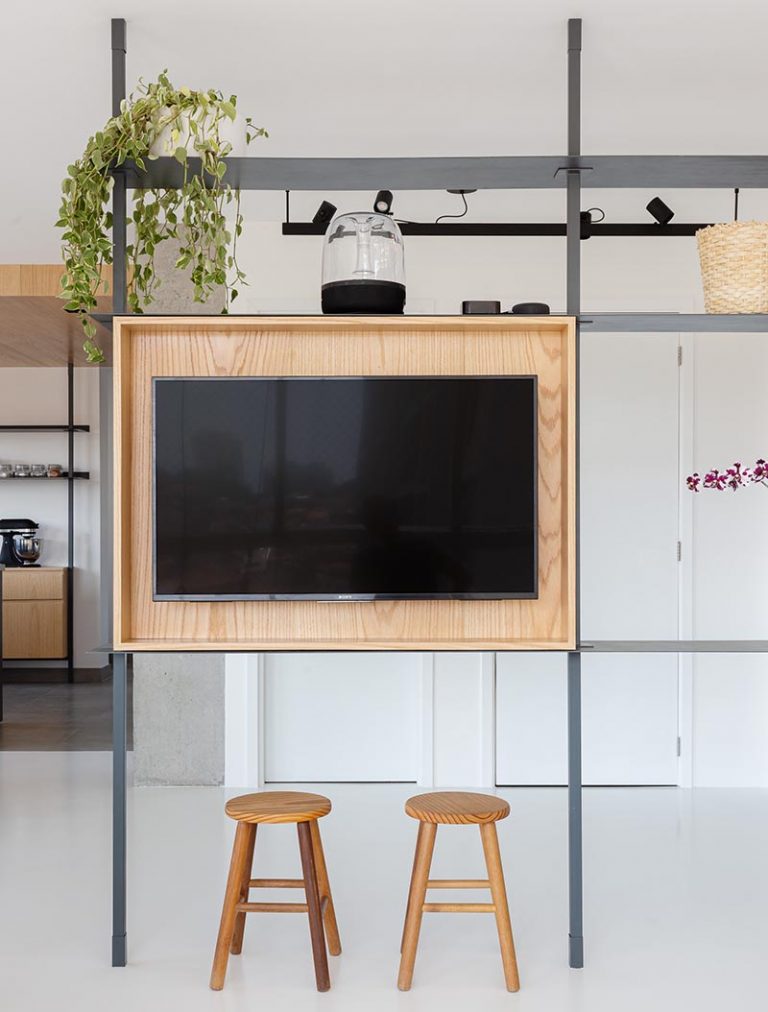 A MultiFunctional Room Divider Helps To Define The Spaces In This