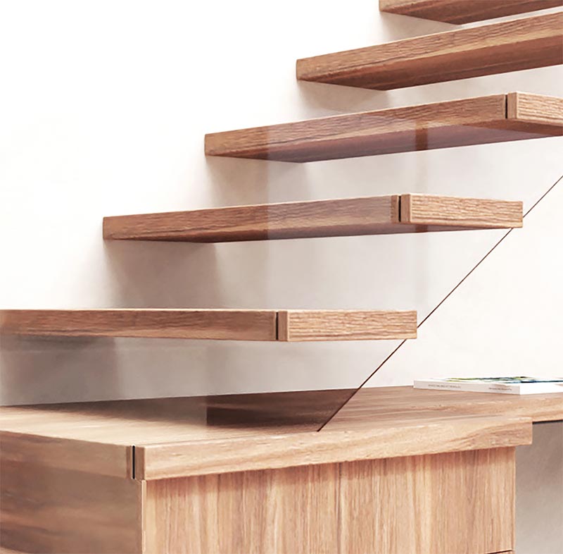 Here's a closer look that shows how the glass safety railing has been incorporated into the design of these modern wood stairs. By attaching the glass to the end of the stair treads, they are able to have it follow the shape of the stairs that makes it almost disappear, creating the sense of floating stairs. #ModernWoodStairs #GlassSafetyRailing #StairDesign