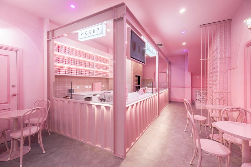 A modern monochromatic pink bakery interior draws inspiration from ’70s California motel aesthetic. #PinkInterior #MonochromaticInterior #Bakery #RetailDesign #CafeDesign