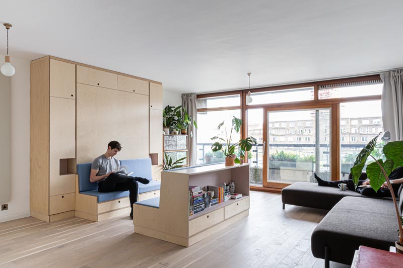 Intervention Architecture have renovated a small apartment in London, that includes a piece of multi-functional furniture that turns into a seating area, a dining area, and a bed. #MultiFunctionalFurniture #FoldDownBed #MurphyBed #SmallApartment #StudioApartment #InteriorDesign