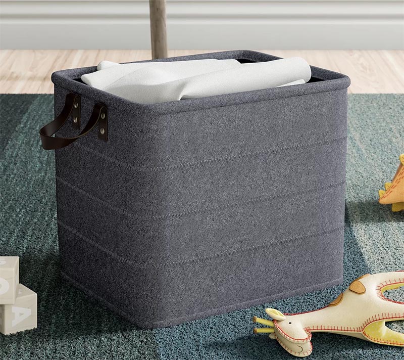 For a casual storage idea, a simple but effective solution is a basket. You can keep it in the corner of the room, and when needed, a blanket can be thrown into it, without the need of keeping it folded. #StorageBasket #HomeDecor #BlanketStorage