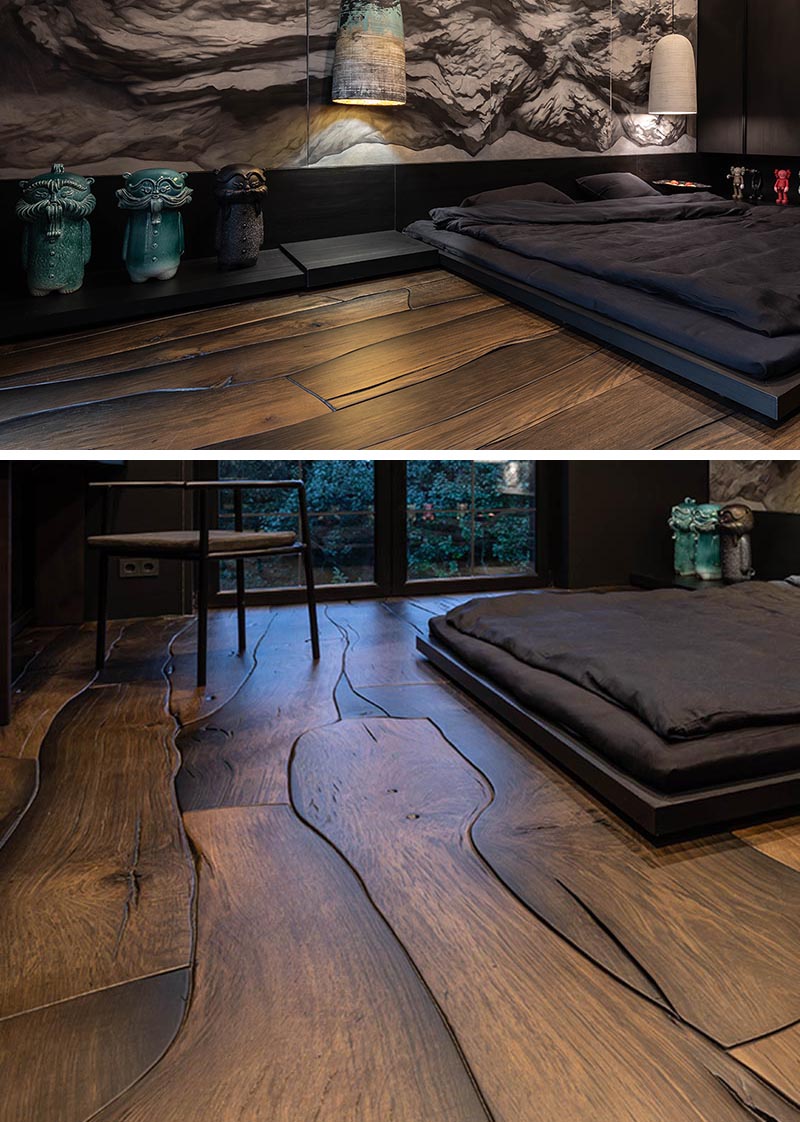This modern bedroom features a unique wood floor made from 500-year-old oak, that fits together like puzzle pieces and showcases the natural grain, cracks, and knots. 