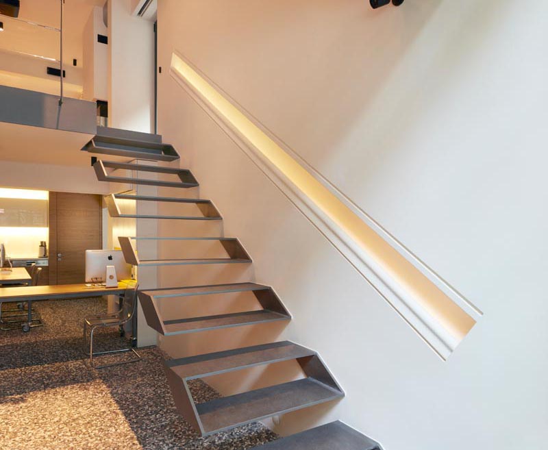 The handrail, which has been built directly into the wall and is the same length as the stairs, provides a guide for people using the stairs as it also has hidden lighting. #Handrail #HiddenLighting #Interiors #Lighting #HandrailLighting #StairDesign