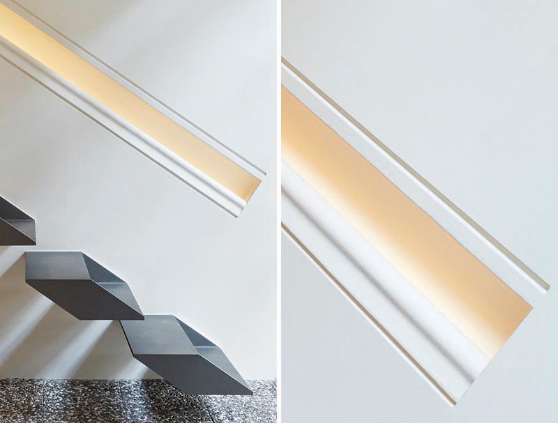 The handrail, which has been built directly into the wall and is the same length as the stairs, provides a guide for people using the stairs as it also has hidden lighting. #Handrail #HiddenLighting #Interiors #Lighting #HandrailLighting #StairDesign