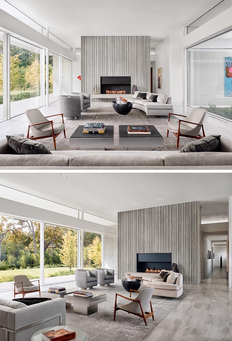 Corrugated concrete was used for the fireplace surround inside this home in the living room. This not only adds a textural element to the modern interior, but also helps to create a sense of height through the use of vertical lines.  #ConcreteWalls #CorrugatedConcrete #ConcreteFireplace #FireplaceSurround