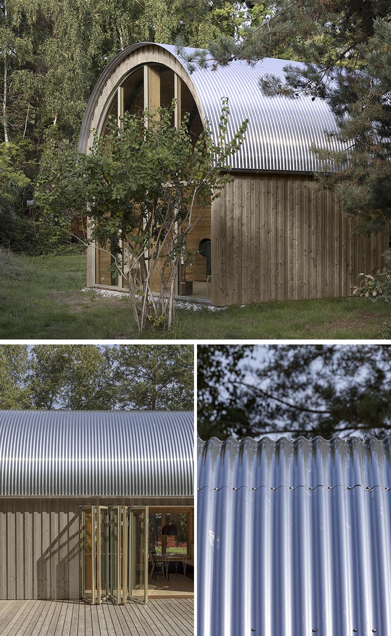 Valbæk Brørup Architects has designed a modern summer house that features a corrugated metal roof and a warm wood interior with a vaulted ceiling. #CorrugatedMetalRoof #MetalRoof #CurvedRoof #ModernArchitecture #ModernHouse
