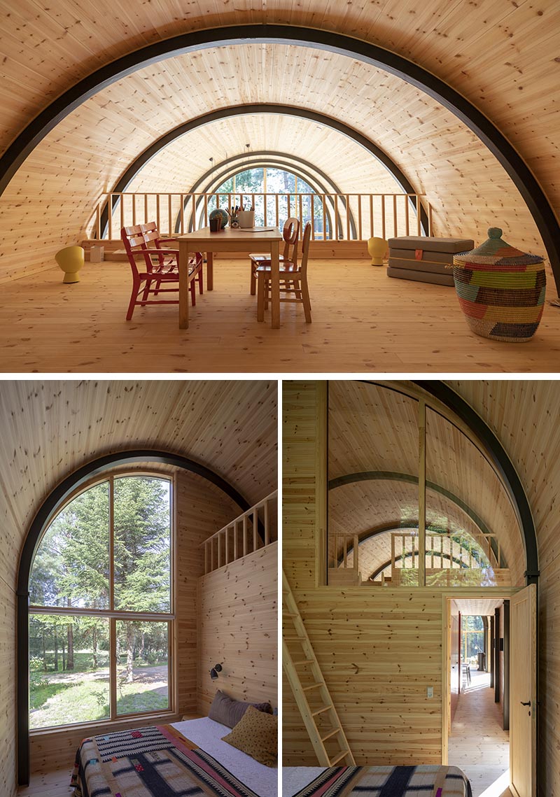 Inside this modern house with a curved vaulted ceiling, there's 8 eye-catching arched steel beams that provide the support for the structure, and at the same time, they create a strong contrast to the minimalist pine wood interior. #CurvedCeiling #VaultedCeiling #PineInterior #WoodInterior #ArchedBeams #SteelBeams #ModernHouse