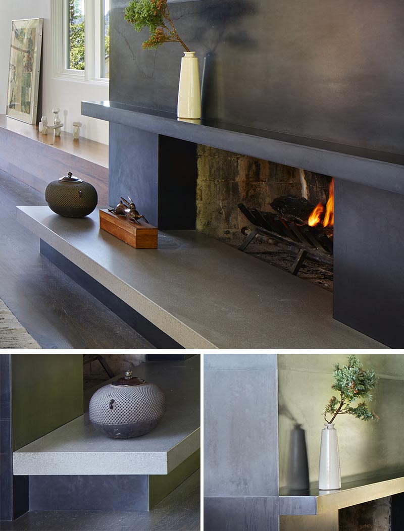 This modern blackened steel fireplace surround with a concrete hearth, creates an eye-catching detail in the living room.  #ModernFireplace #SteelFireplaceSurround #SteelFireplace #ConcreteHearth #ModernLivingRoom