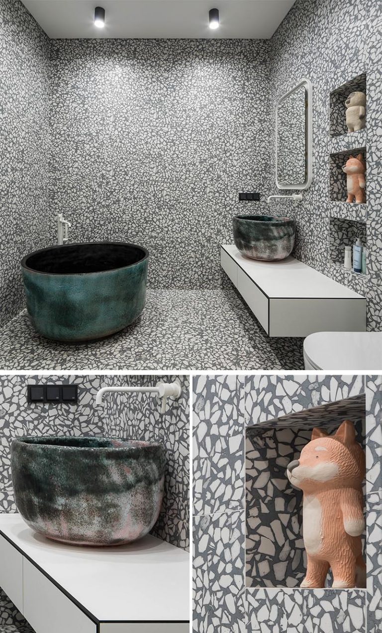 White And Grey Terrazzo Tile Completely Cover The Walls And Floor Of This Bathroom With Soaking Tub