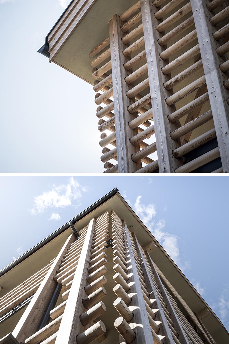 Rows of wood poles have been threaded through vertical supports, and surround the solid walls of this modern hotel, creating a look reminiscent of local farmhouses. #HotelDesign #WoodExterior #LogWood #WoodFacade #Architecture