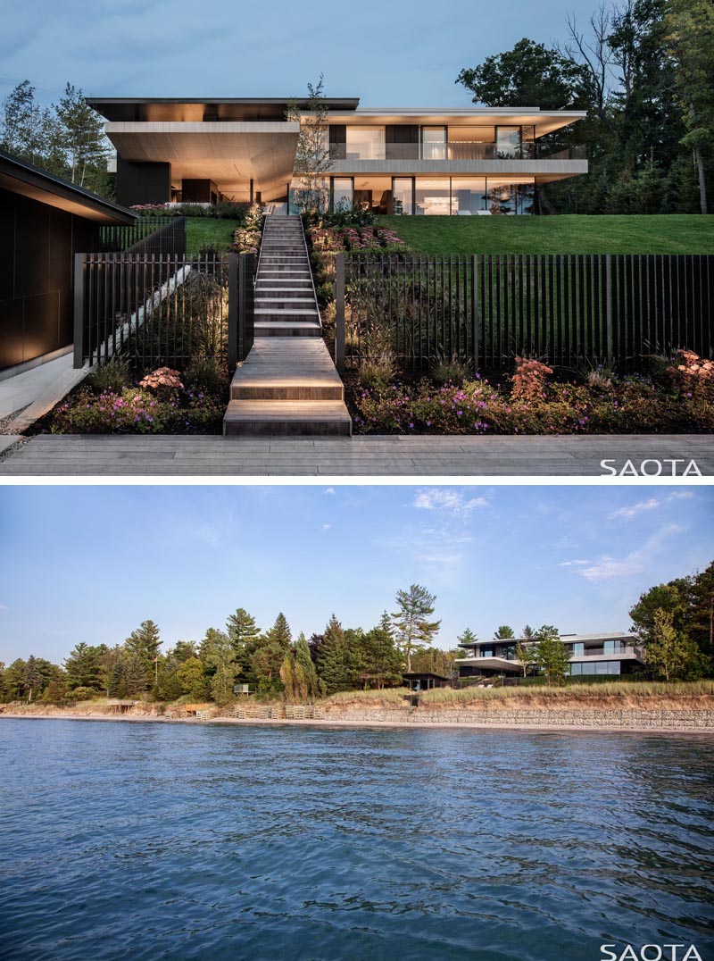This modern lake house has stairs that travel down the slope to a refurbished cabin that predates the house, and is now a guest suite or an additional outdoor entertaining area. #ModernLakeHouse #ExteriorStairs #Landscaping